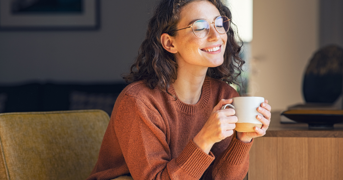 woman smiling drinking the specialty coffee that is good for per taste